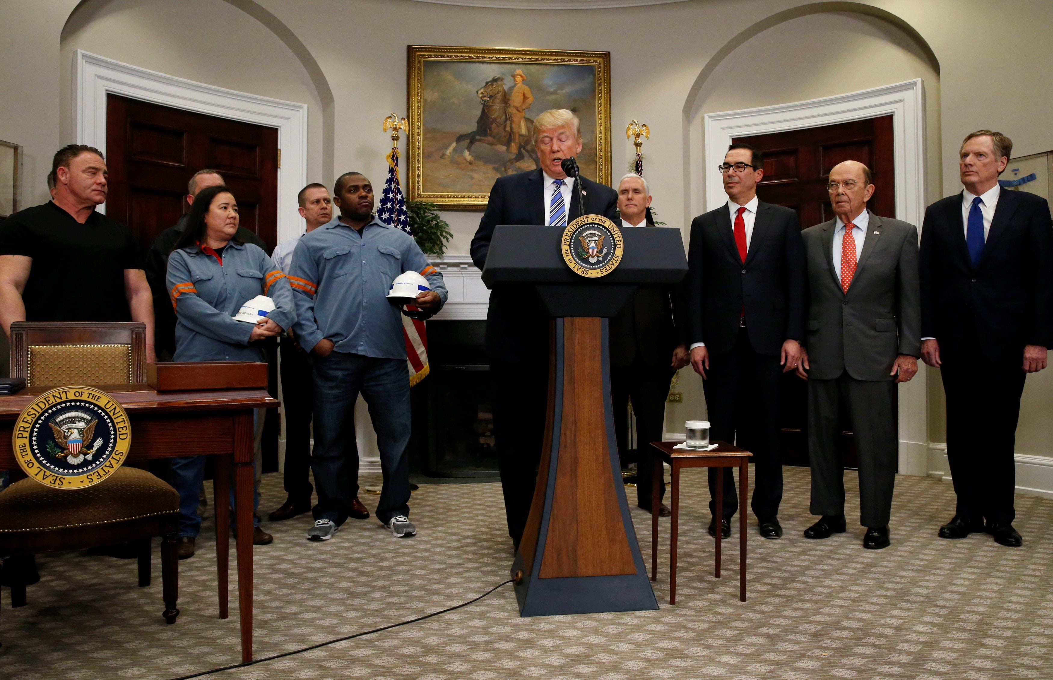 U.S. President Donald Trump speaks as he signs a presidential