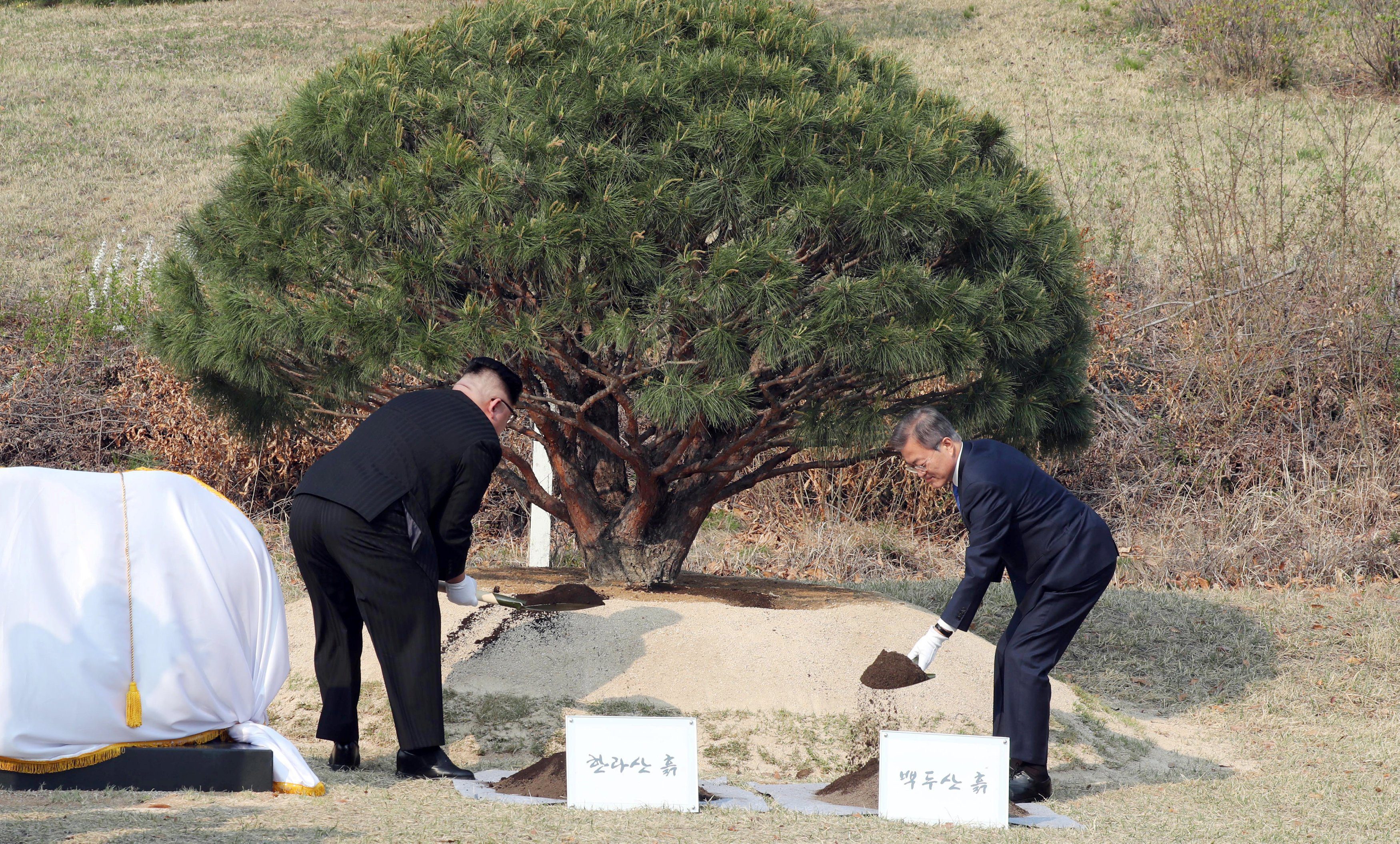 South Korean President Moon Jae-in and North Korean leader Kim Jong Un plant a commemorative tree at the truce village of Panmunjom