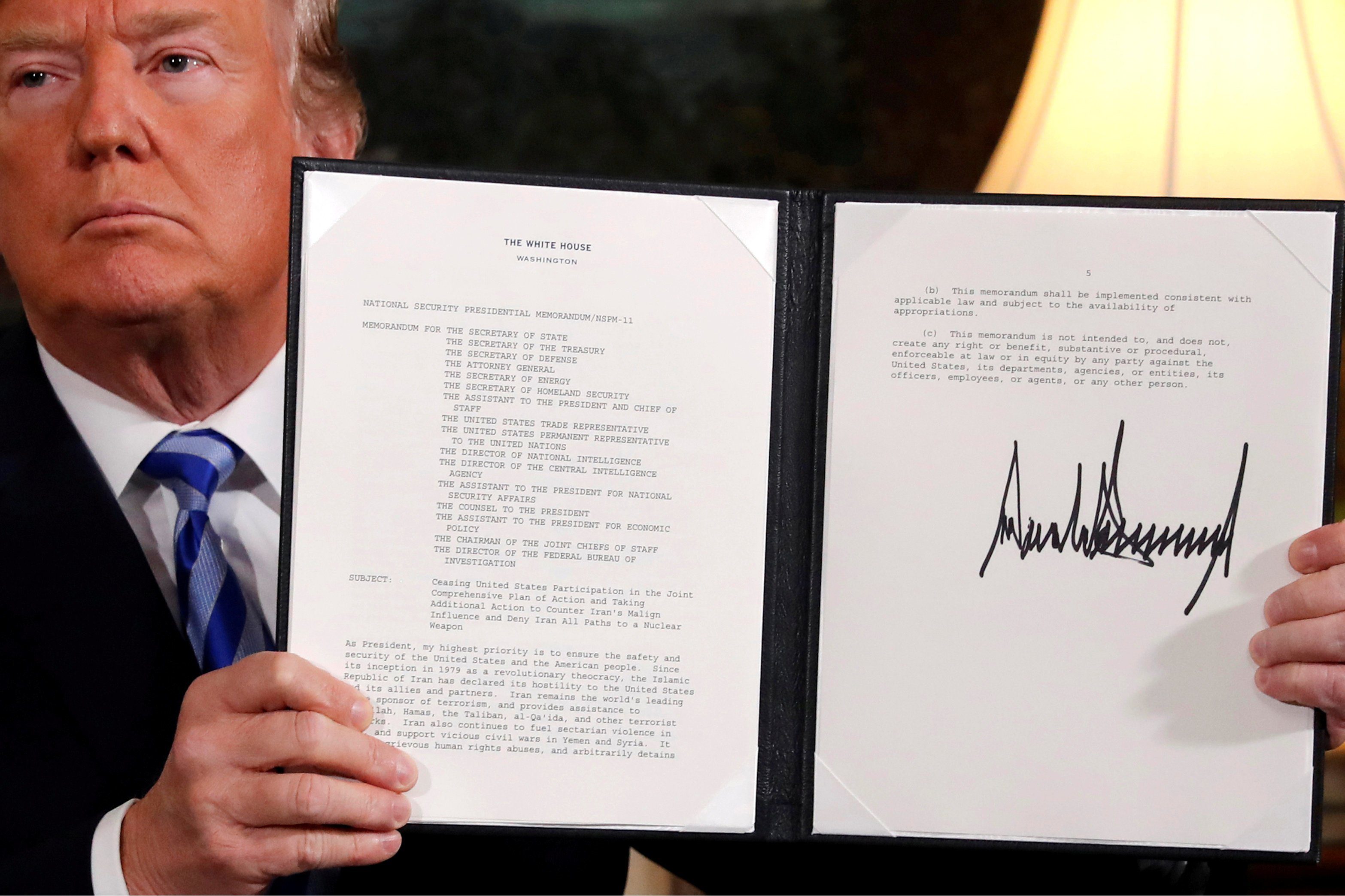 FILE PHOTO: U.S. President Donald Trump holds up a proclamation declaring his intention to withdraw from the JCPOA Iran nuclear agreement