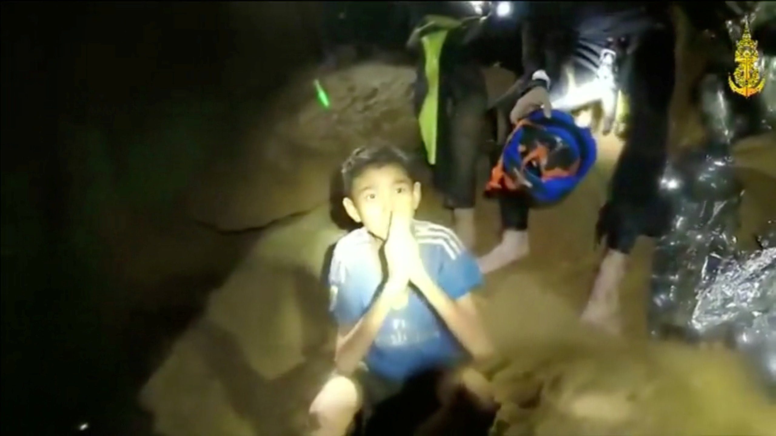 Boys from the under-16 soccer team trapped inside Tham Luang cave greet members of the Thai rescue team in Chiang Rai, Thailand