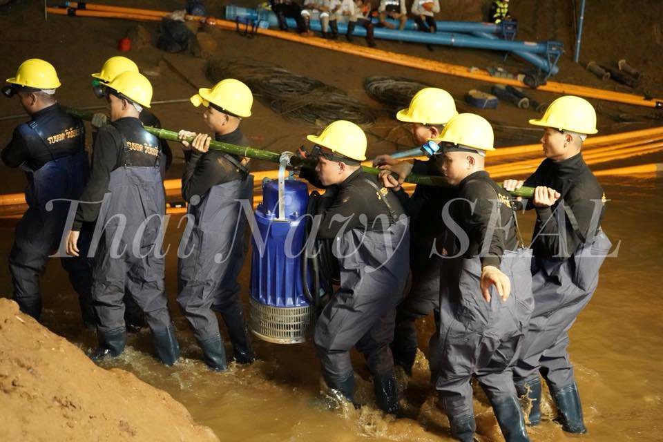 Rescue personnel work at the Tham Luang cave complex, as members of an under-16 soccer team and their coach have been found alive according to local media, in the northern province of Chiang Rai
