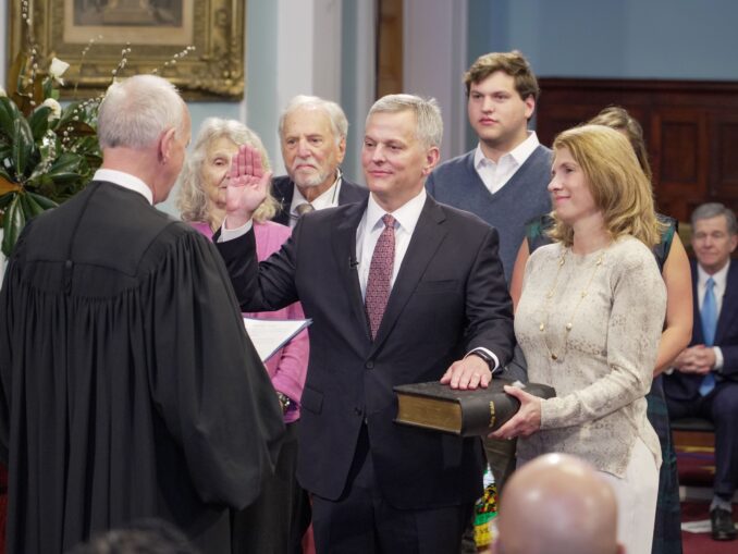 Josh Stein (D-N.C.), center, is sworn in as Governor of North Carolina on January 1, 2024, by N.C. Chief Justice Paul M. Newby (R-N.C.) at the State Capitol in Raleigh.